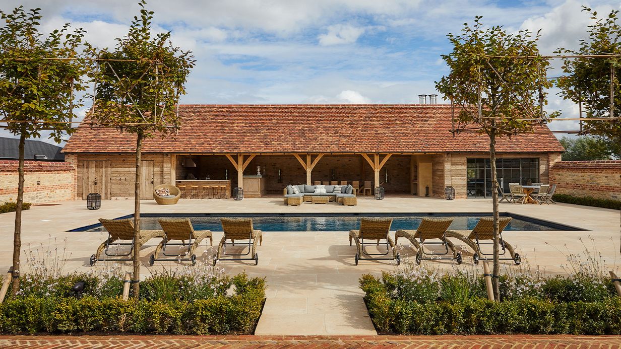 Image may contain: Architecture, Building, House, Housing, Villa, Chair, Furniture, Backyard, Nature, Outdoors, and Yard