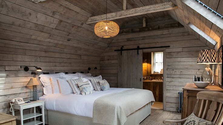 Image may contain: Indoors, Interior Design, Chair, Furniture, Lamp, Bed, Architecture, Building, Housing, House, and Loft