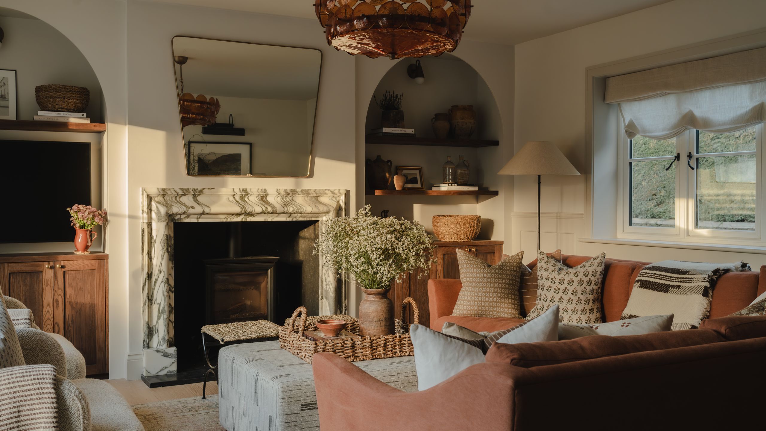 Image may contain: Home Decor, Lamp, Couch, Furniture, Architecture, Building, Indoors, Living Room, Room, Plant, and Art