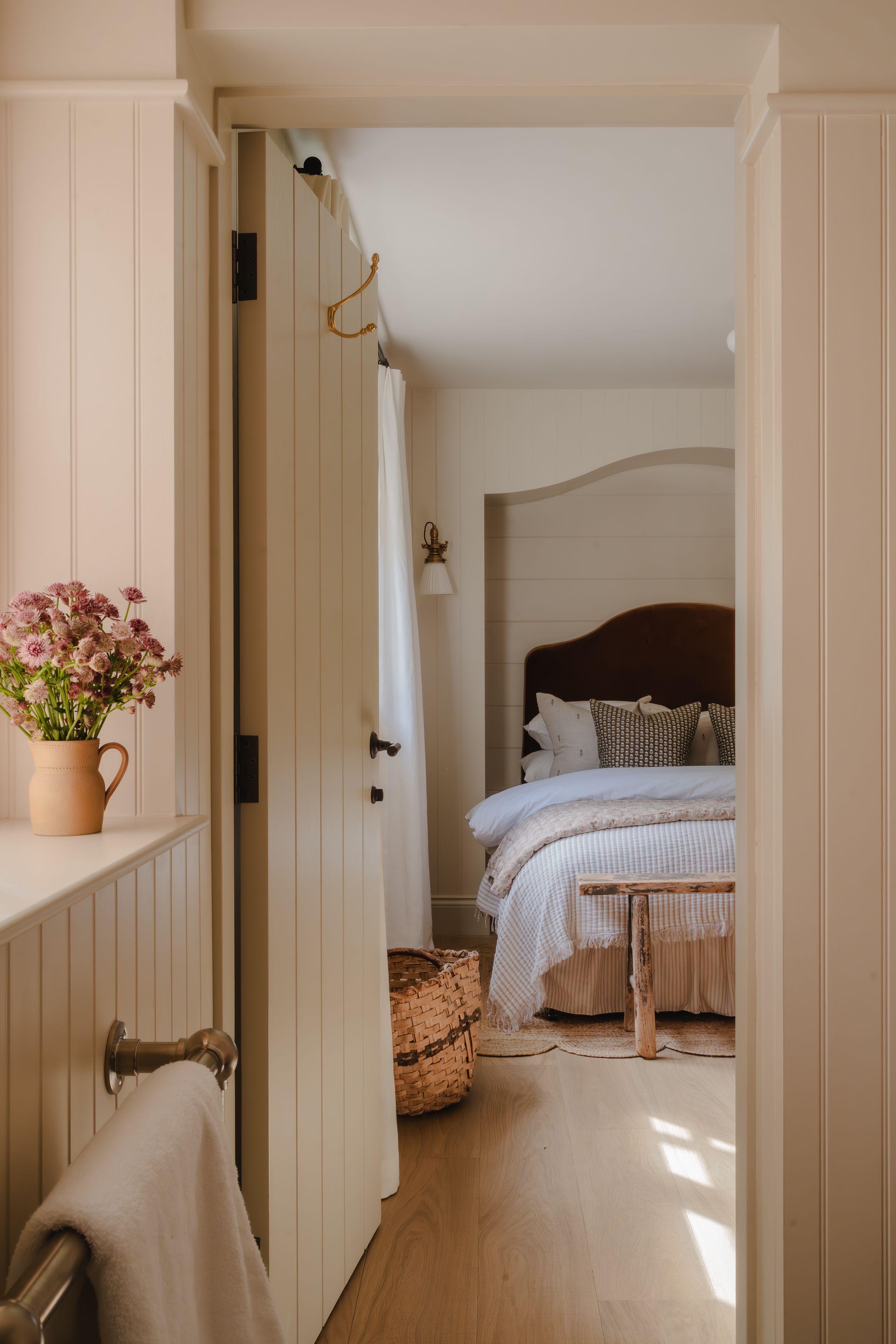 Image may contain: Indoors, Interior Design, Lamp, Bed, Furniture, Flower, Flower Arrangement, Plant, Bedroom, and Room