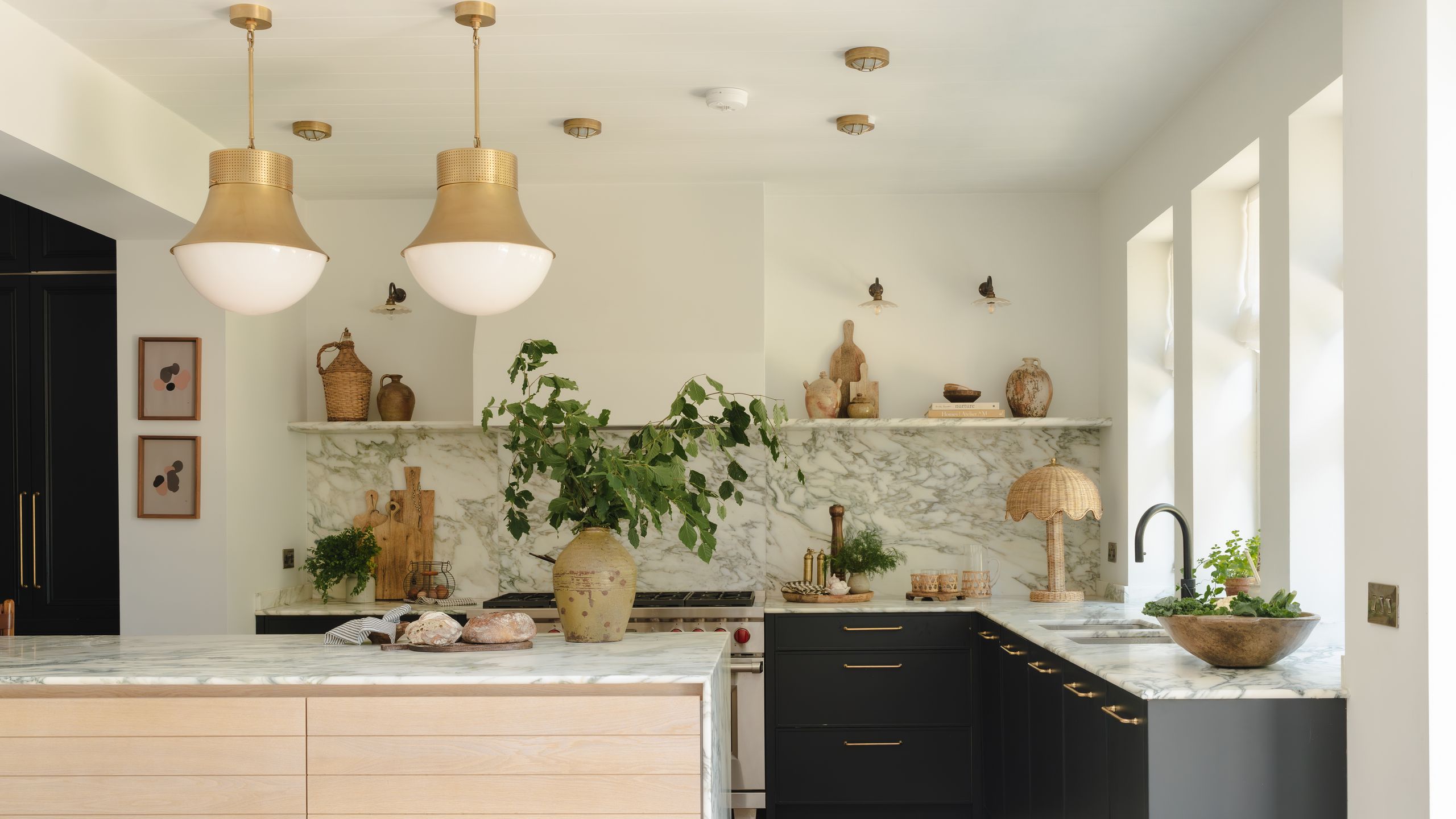 Image may contain: Indoors, Interior Design, Kitchen, Kitchen Island, Plant, Person, and Home Decor