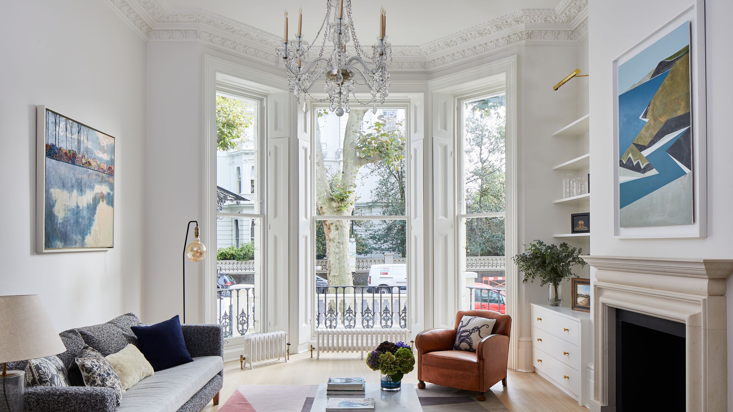 Image may contain: Lamp, Home Decor, Architecture, Building, Furniture, Indoors, Living Room, Room, Couch, Rug, and Car