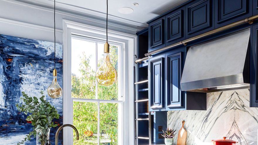 Image may contain: Indoors, Interior Design, Kitchen, Lamp, Sink, Cooktop, Sink Faucet, Plant, and Kitchen Island