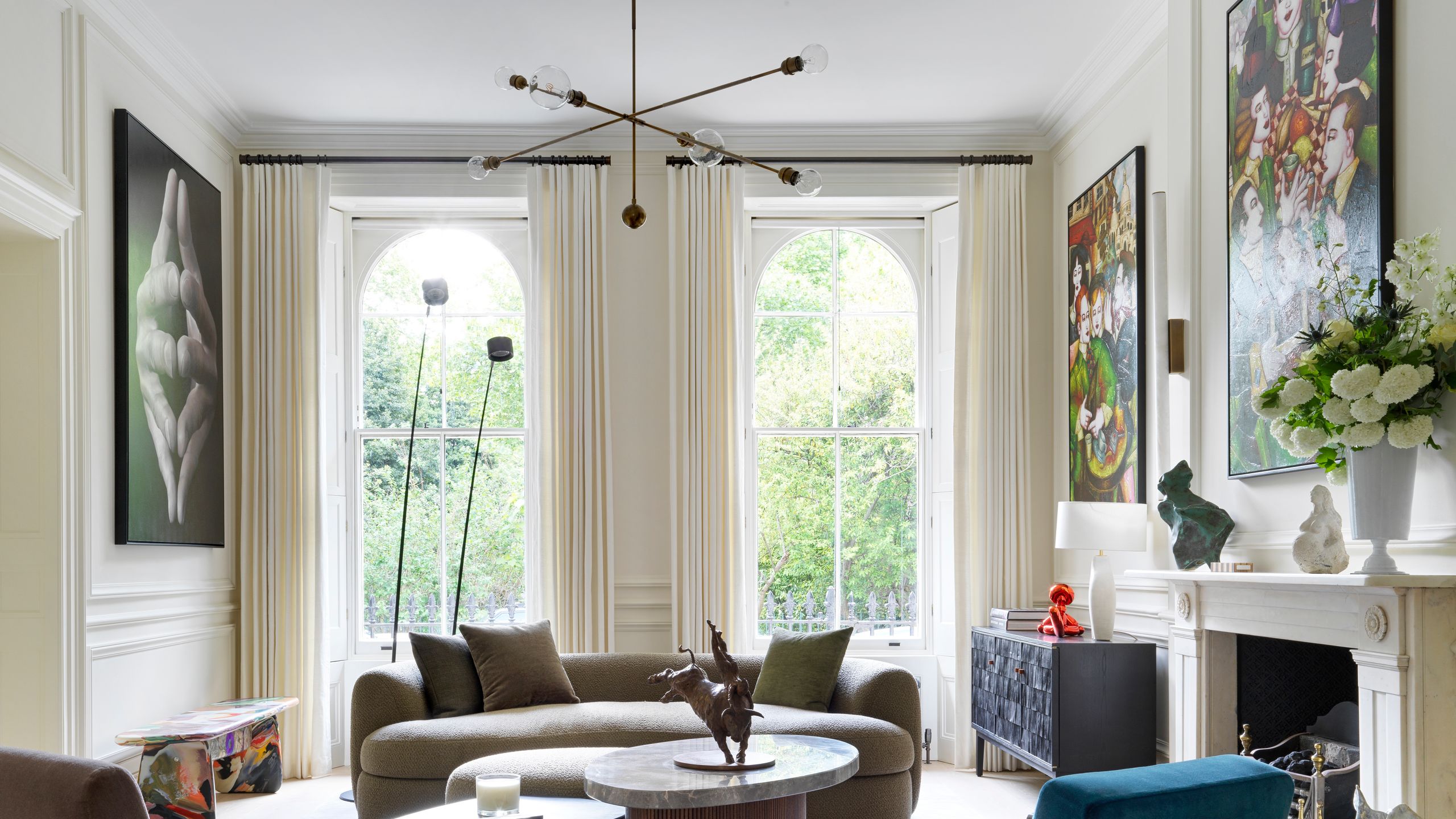 Image may contain: Home Decor, Coffee Table, Furniture, Table, Lamp, Couch, Chair, Art, Painting, Architecture, and Building