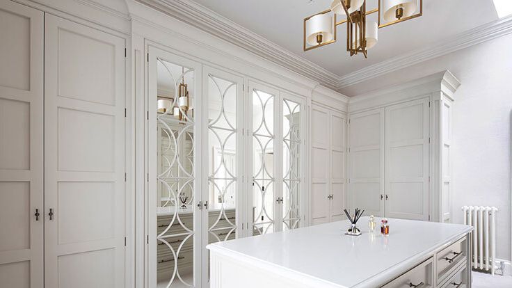 Image may contain: Indoors, Interior Design, Chandelier, Lamp, Door, Furniture, and Home Decor