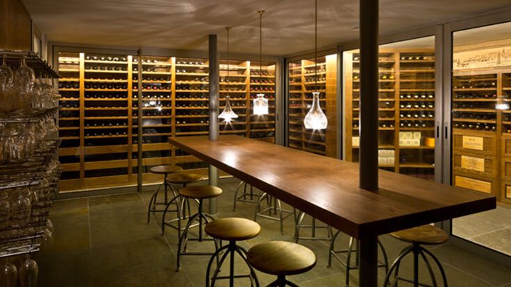 Image may contain: Alcohol, Beverage, Liquor, Wine, Desk, Furniture, Table, Lamp, and Wine Cellar