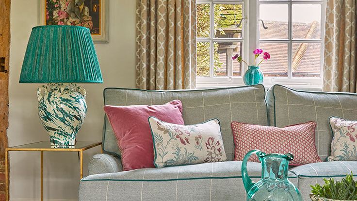 Image may contain: Cushion, Home Decor, Couch, Furniture, Lamp, Plant, Art, Painting, Pillow, Architecture, and Building