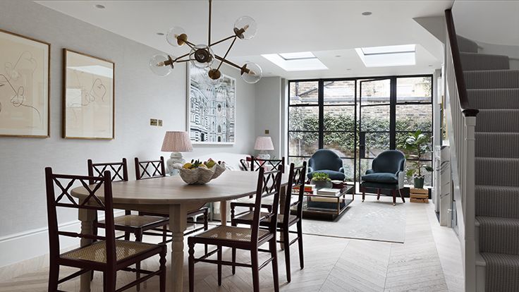 Image may contain: Architecture, Building, Dining Room, Dining Table, Furniture, Indoors, Room, Table, Lamp, Floor, and Chair