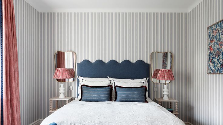 Image may contain: Indoors, Interior Design, Lamp, Bed, Furniture, Cushion, Home Decor, Art, Painting, Wood Panels, and Couch