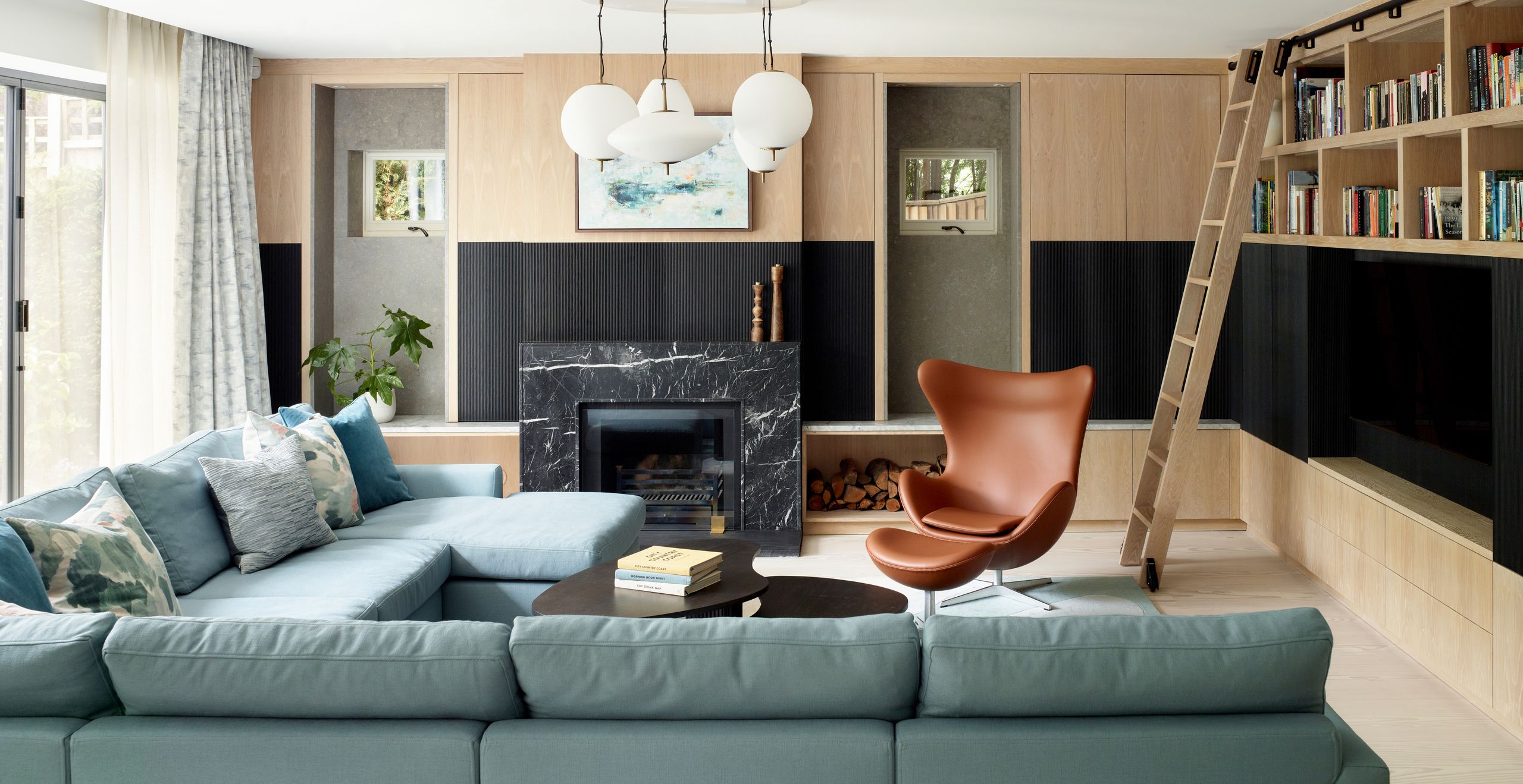 Image may contain: Architecture, Building, Furniture, Indoors, Living Room, Room, Plant, Home Decor, and Chair