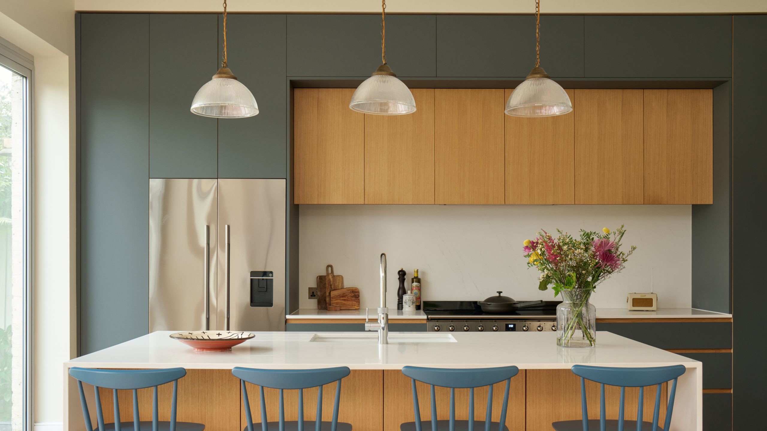 Image may contain: Indoors, Interior Design, Kitchen, Chair, Furniture, Kitchen Island, Dining Table, Table, and Architecture