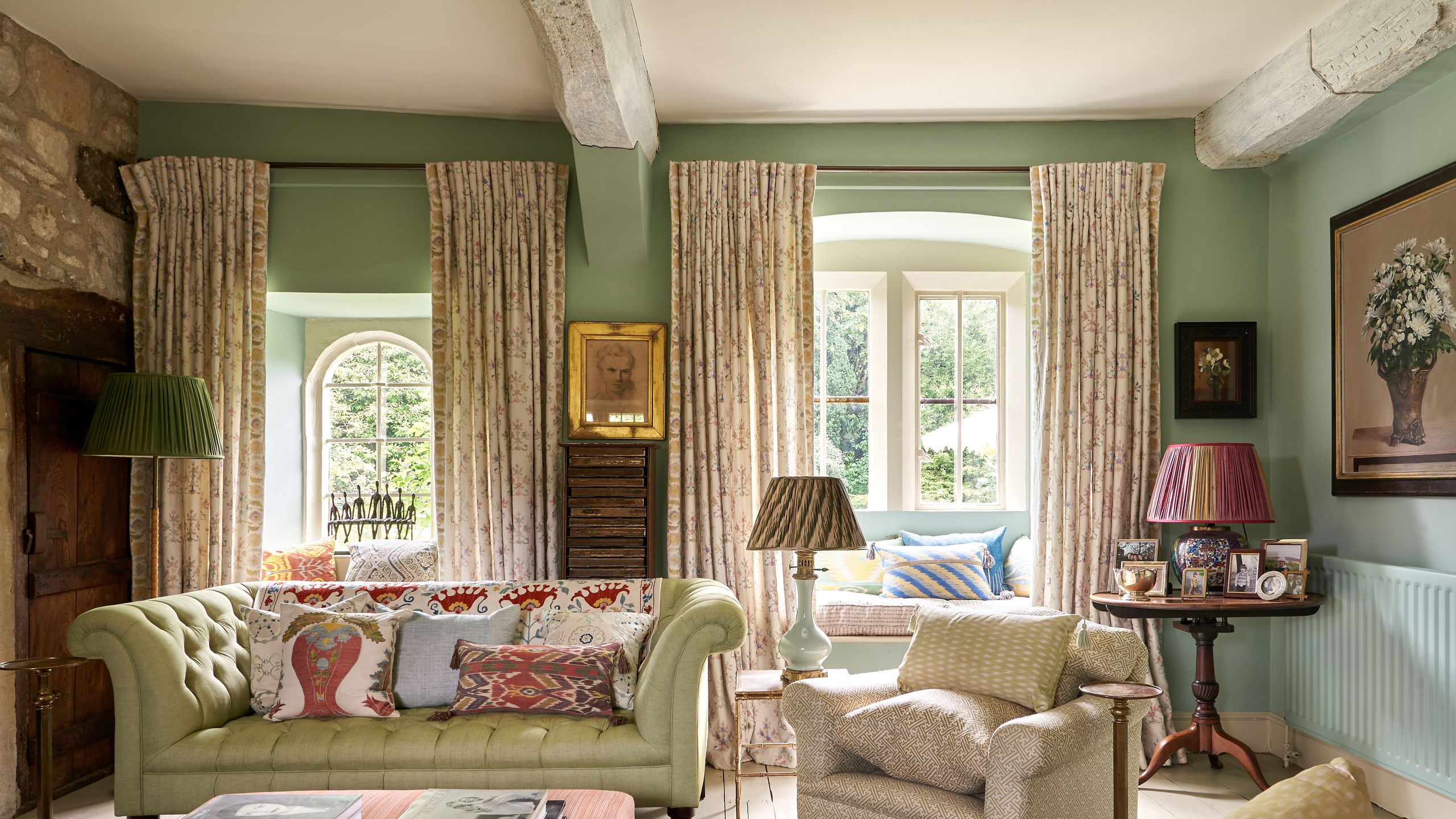 Image may contain: Lamp, Home Decor, Book, Publication, Desk, Furniture, Table, Couch, Architecture, Building, and Indoors