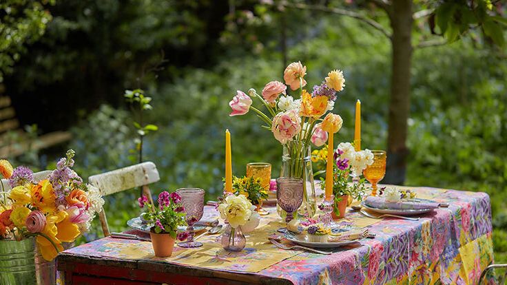 Image may contain: Furniture, Table, Tabletop, Flower, Flower Arrangement, Plant, Flower Bouquet, Outdoors, Chair, and Nature