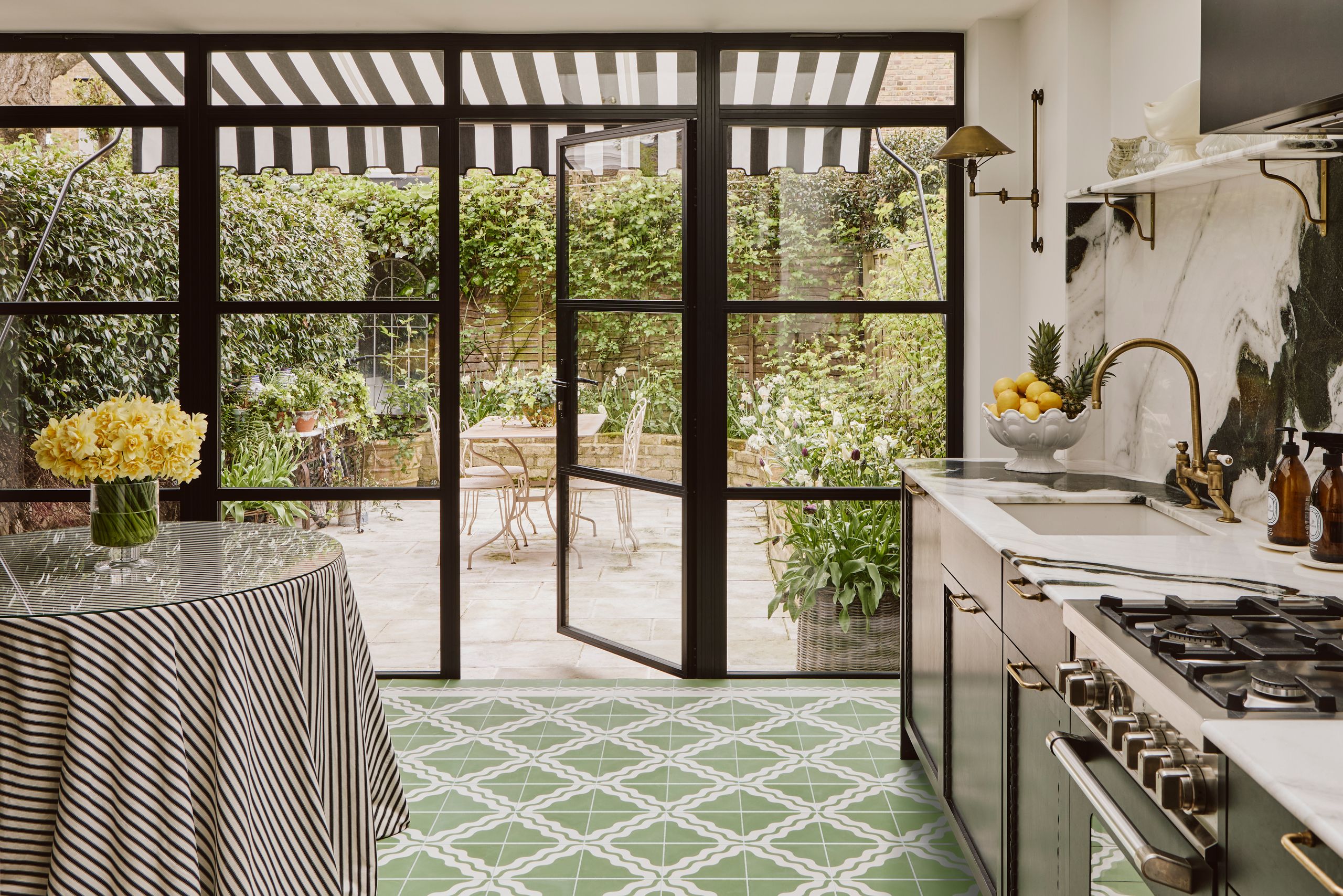 Image may contain: Door, Indoors, Interior Design, Desk, Furniture, Table, Sink, Kitchen, Chair, Architecture, and Building