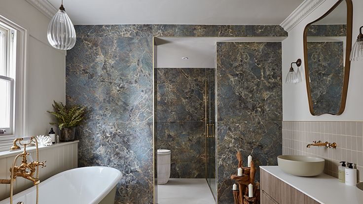 Image may contain: Sink, Plant, Lamp, Bathing, Bathtub, Person, Tub, Indoors, Interior Design, Sink Faucet, and Candle