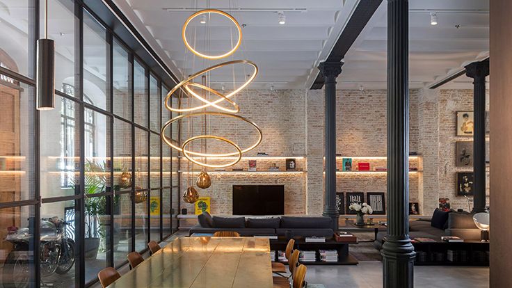 Image may contain: Indoors, Architecture, Building, Foyer, Chair, Furniture, Lamp, Couch, Motorcycle, and Transportation