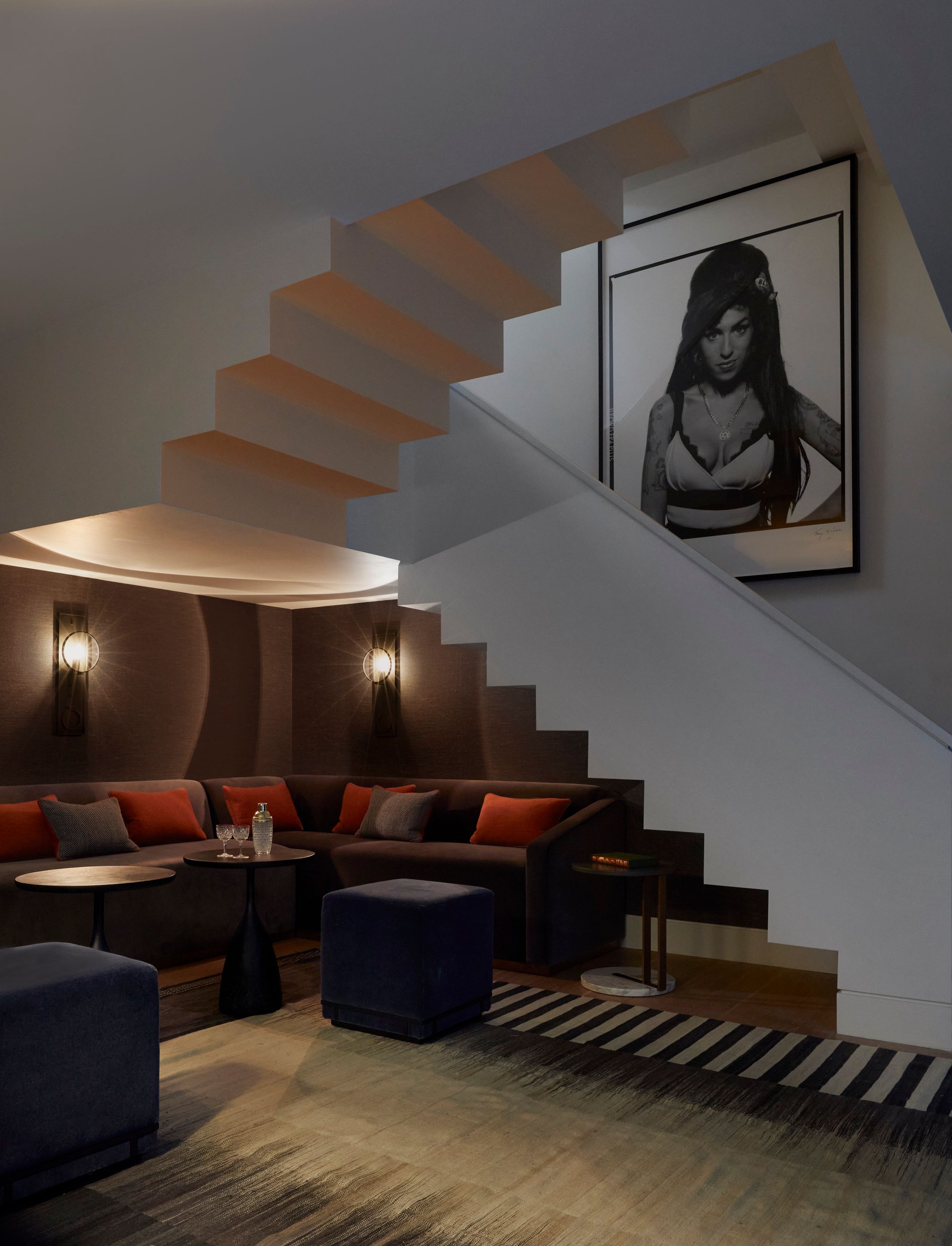 Image may contain: Amy Winehouse, Architecture, Building, House, Housing, Staircase, Furniture, Indoors, and Living Room