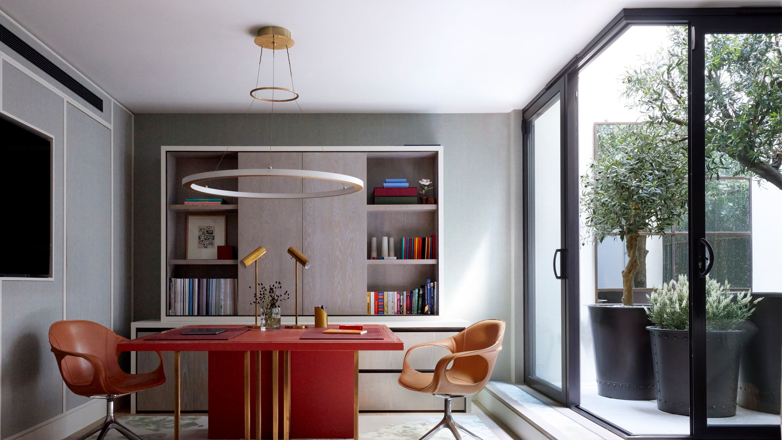 Image may contain: Chair, Furniture, Table, Desk, Indoors, Interior Design, Plant, Lamp, Door, Home Decor, and Candle