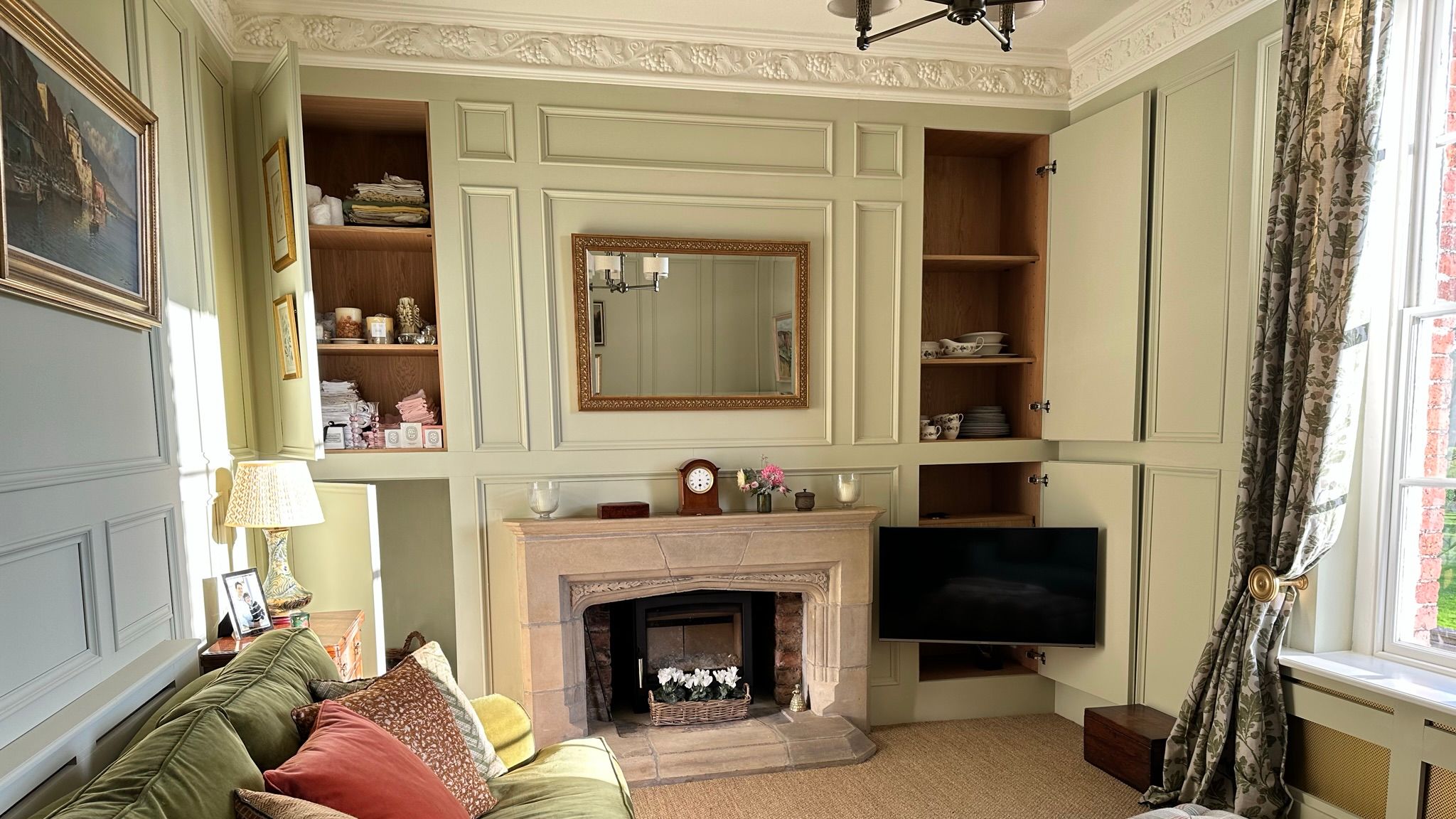 Image may contain: Lamp, Home Decor, Couch, Furniture, Art, Painting, Indoors, Interior Design, and Fireplace