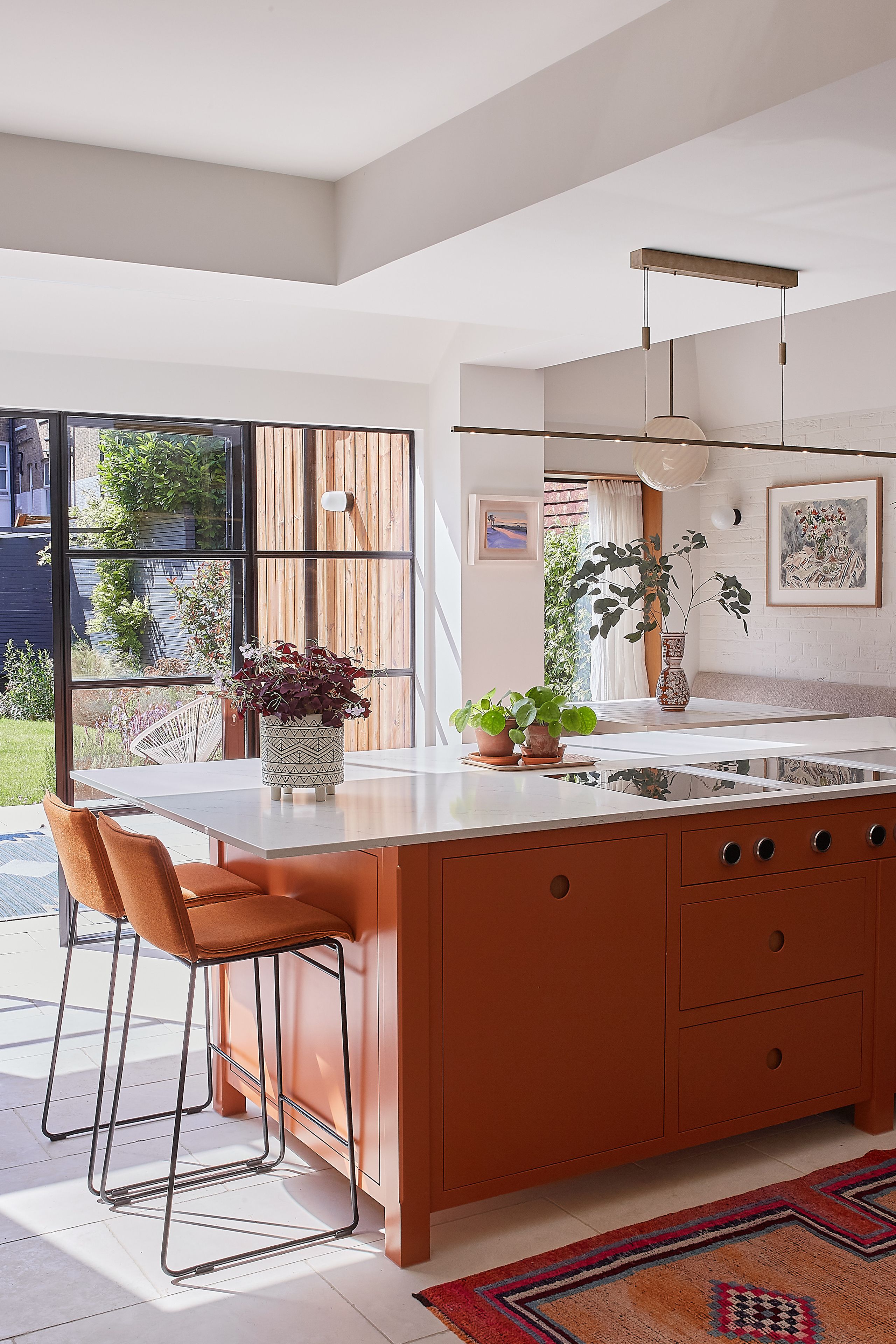 Image may contain: Indoors, Interior Design, Kitchen, Plant, Kitchen Island, Home Decor, Rug, Chair, Furniture, and Art