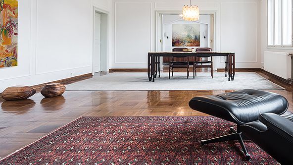 Image may contain: Home Decor, Rug, Floor, Flooring, Chair, Furniture, Desk, Table, Lamp, Indoors, Interior Design, and Wood