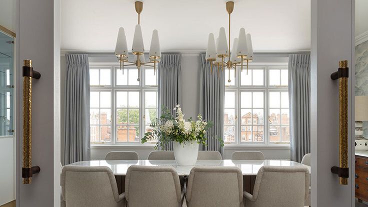 Image may contain: Architecture, Building, Dining Room, Dining Table, Furniture, Indoors, Room, Table, Chandelier, and Lamp