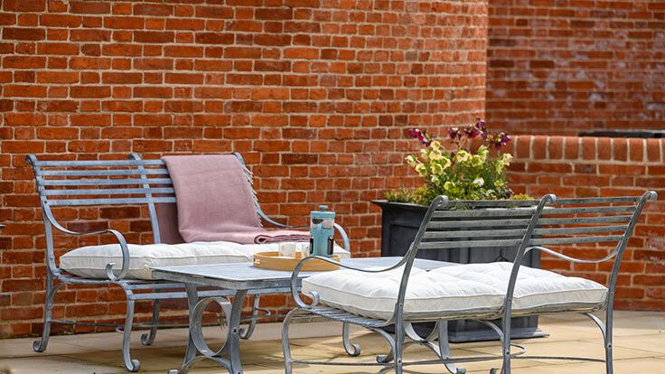 Image may contain: Furniture, Table, Bench, Indoors, Interior Design, Chair, Plant, Potted Plant, Tabletop, and Dining Table