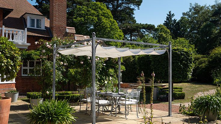 Image may contain: Architecture, Building, House, Housing, Patio, Porch, Backyard, Nature, Outdoors, Yard, Plant, and Pergola