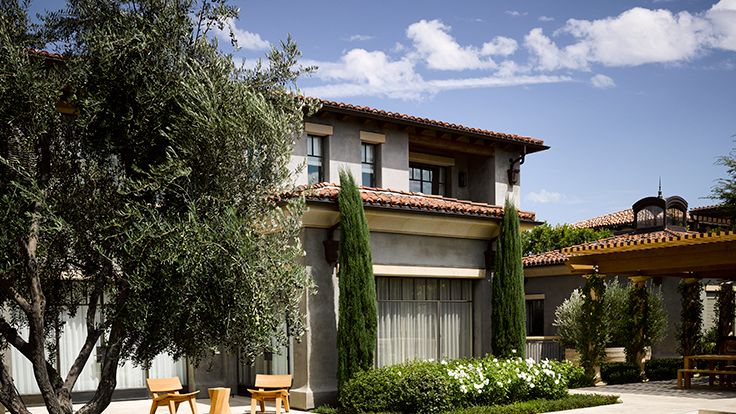 Image may contain: Architecture, Building, House, Housing, Villa, Hacienda, Grass, Plant, Chair, Furniture, Desk, and Table