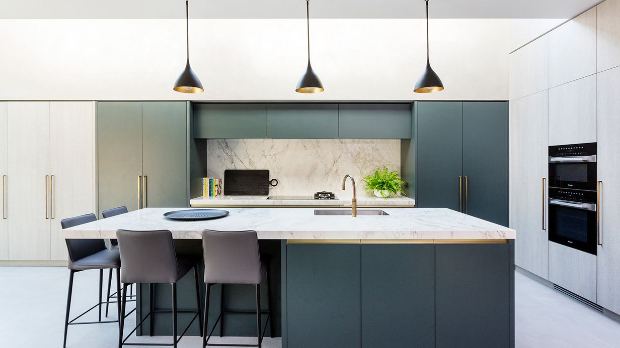 Image may contain: Indoors, Interior Design, Kitchen, Kitchen Island, Dining Table, Furniture, Table, Plant, Chair, and Lamp