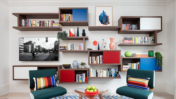 Image may contain: Home Decor, Chair, Furniture, Rug, Plant, Bicycle, Transportation, Vehicle, Bookcase, and Person