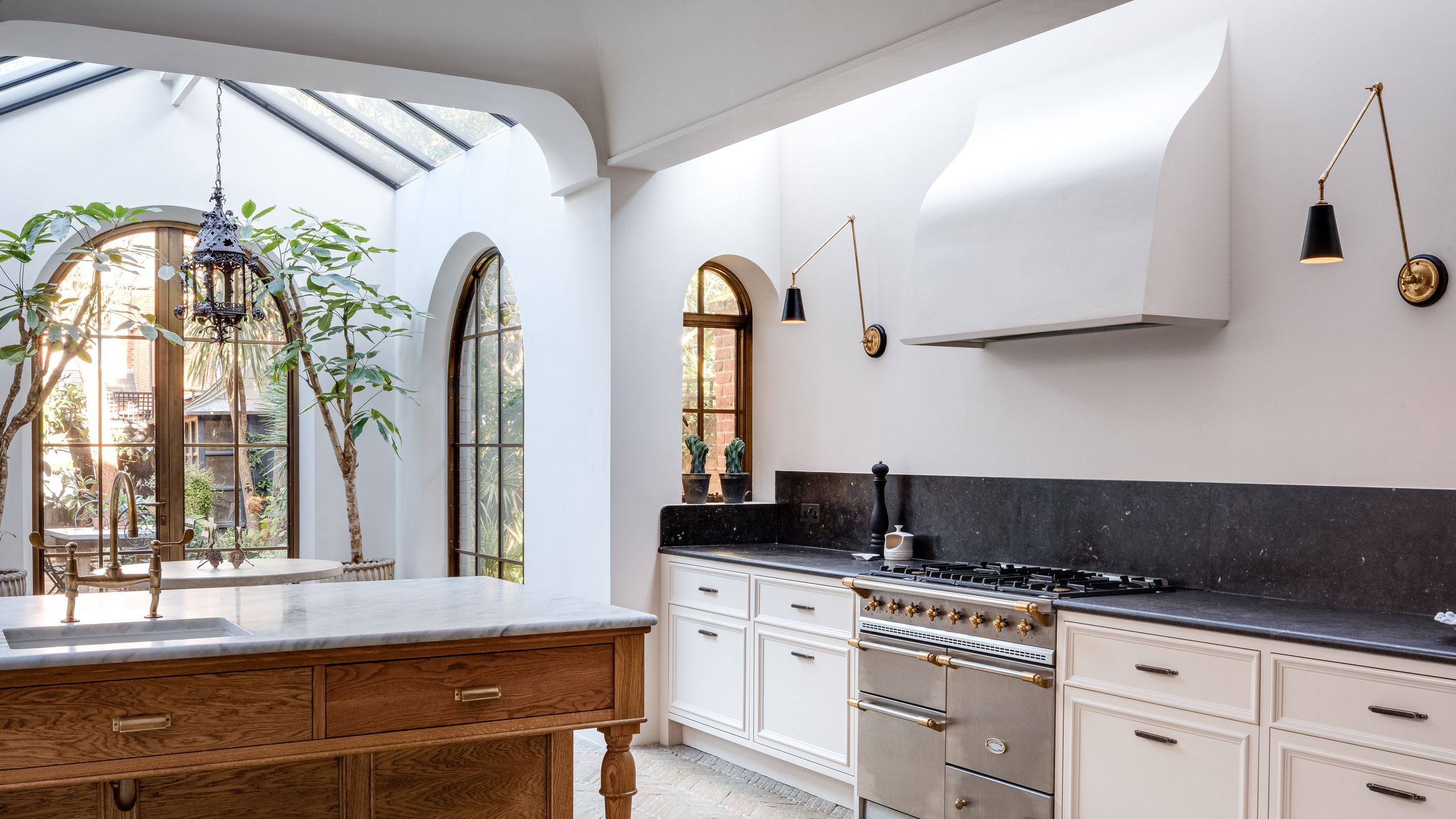 Image may contain: Indoors, Interior Design, Lamp, Plant, Kitchen, Sink, Cooktop, Home Decor, Sink Faucet, and Window