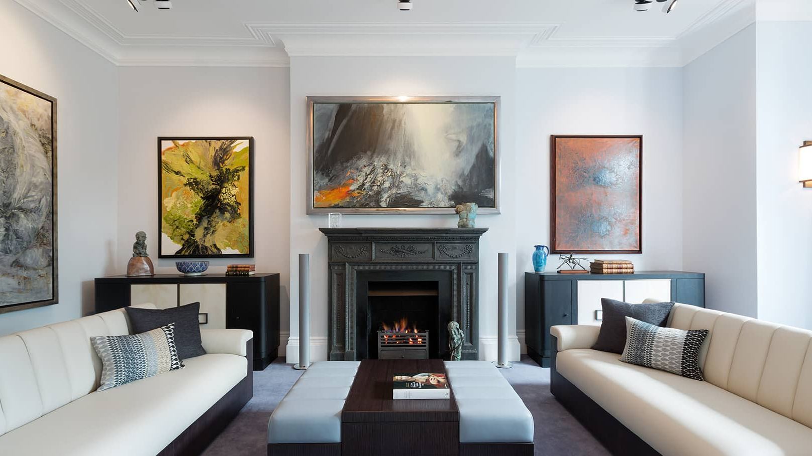 Image may contain: Fireplace, Indoors, Home Decor, Book, Publication, Couch, Furniture, Hearth, Art, Painting, and Table