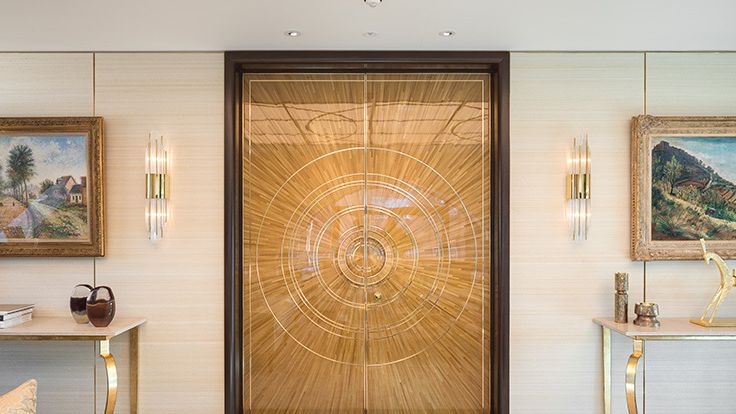 Image may contain: Indoors, Interior Design, Door, Art, Painting, Desk, Furniture, Table, Lamp, Sliding Door, and Wood