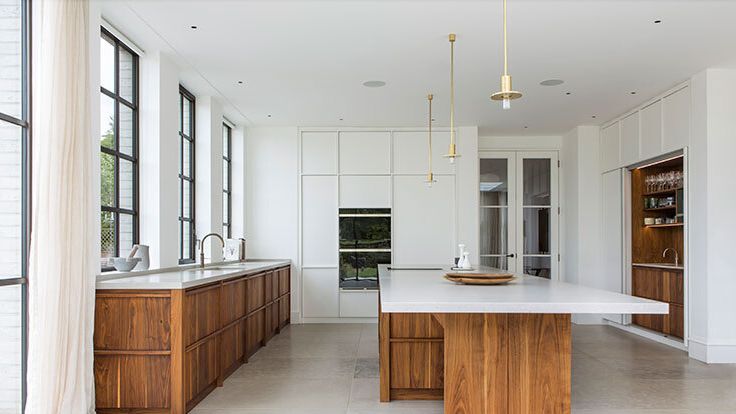 Image may contain: Indoors, Interior Design, Kitchen, Kitchen Island, Lamp, Sink, Sink Faucet, Floor, Wood, and Flooring