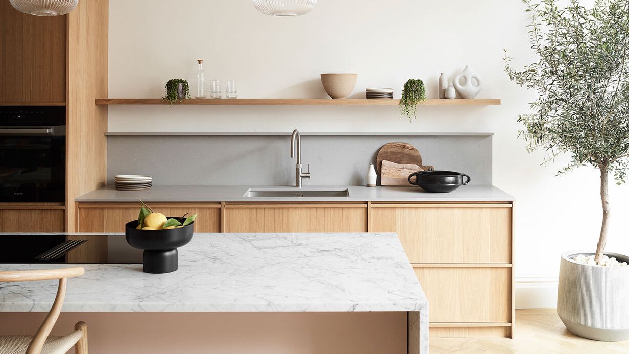 Image may contain: Indoors, Interior Design, Kitchen, Plant, Sink, Sink Faucet, Chair, Furniture, Food, Fruit, and Pear