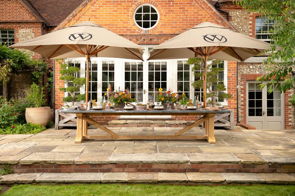 Image may contain Architecture Building House Housing Patio Path Walkway Plant Canopy Patio Umbrella and Door