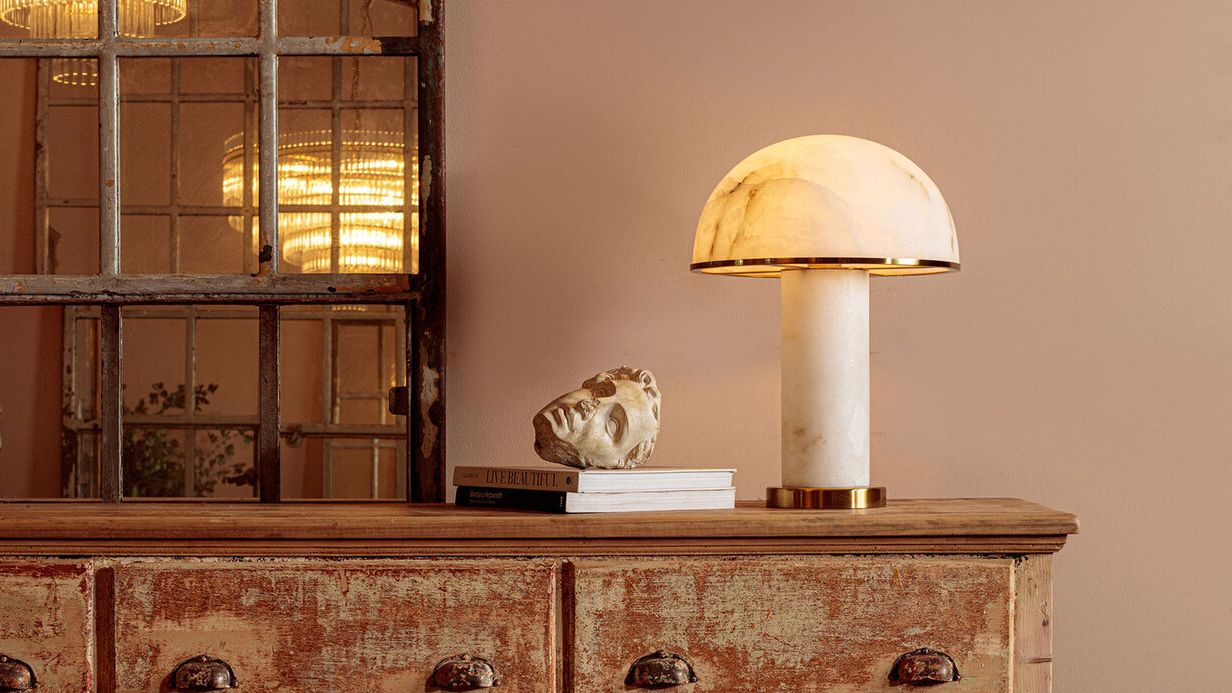 Image may contain: Lamp, Table Lamp, Person, Furniture, Sideboard, and Cabinet