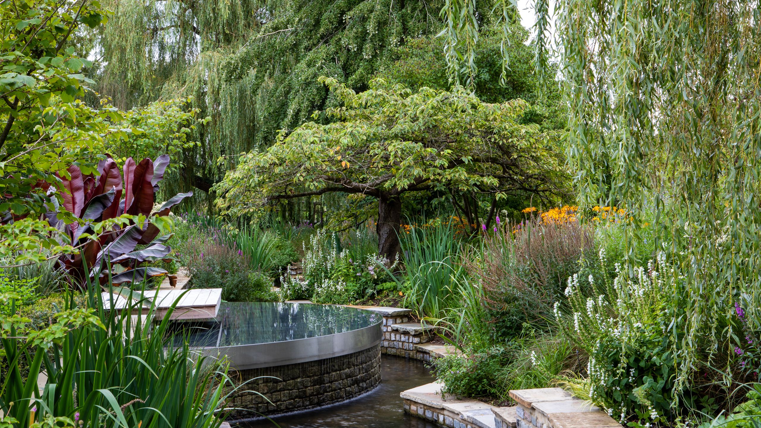 Image may contain: Nature, Outdoors, Pond, Water, Garden, Backyard, Yard, Grass, Plant, Tree, Vegetation, and Park