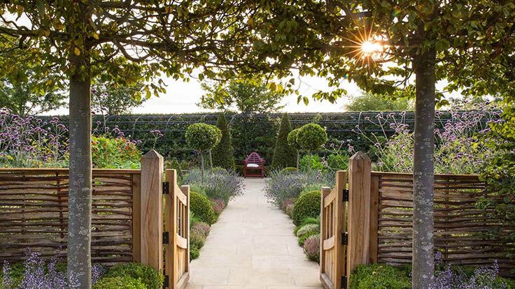 Image may contain: Garden, Nature, Outdoors, Grass, Park, Plant, Yard, Arbour, Architecture, Building, Housing, and Chair