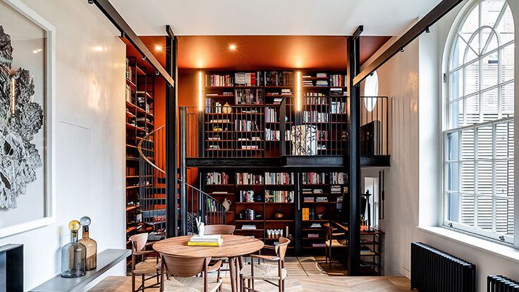 Image may contain: Furniture, Desk, Table, Chair, Bookcase, Architecture, Building, Dining Room, Dining Table, and Indoors