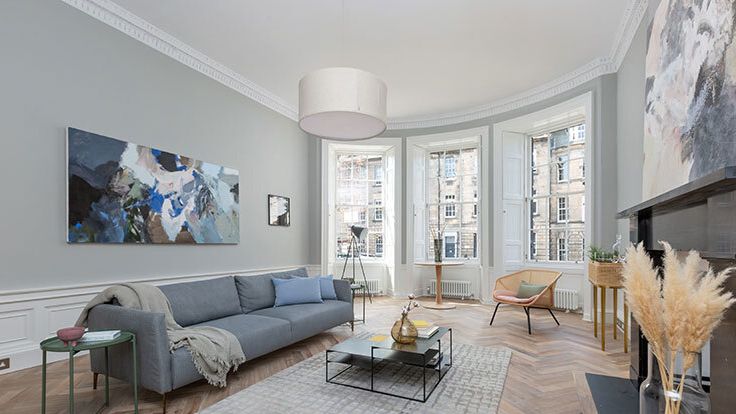 Image may contain: Home Decor, Rug, Chair, Furniture, Couch, Architecture, Building, Indoors, Living Room, Room, and Table