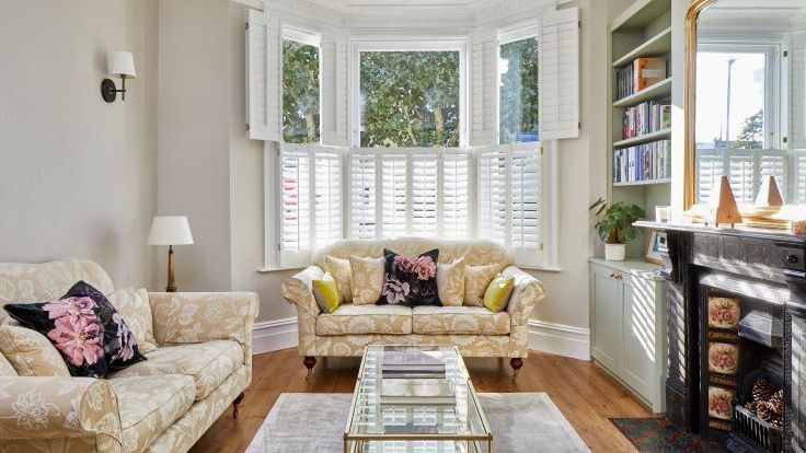 Image may contain: Lamp, Home Decor, Plant, Couch, Furniture, Rug, Window, Table, Architecture, Building, and Indoors