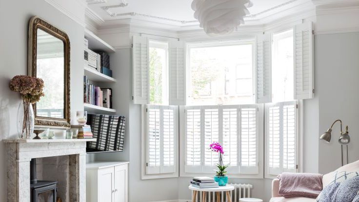 Image may contain: Window, Couch, Furniture, Home Decor, Rug, Bay Window, Cup, Lamp, Desk, and Table