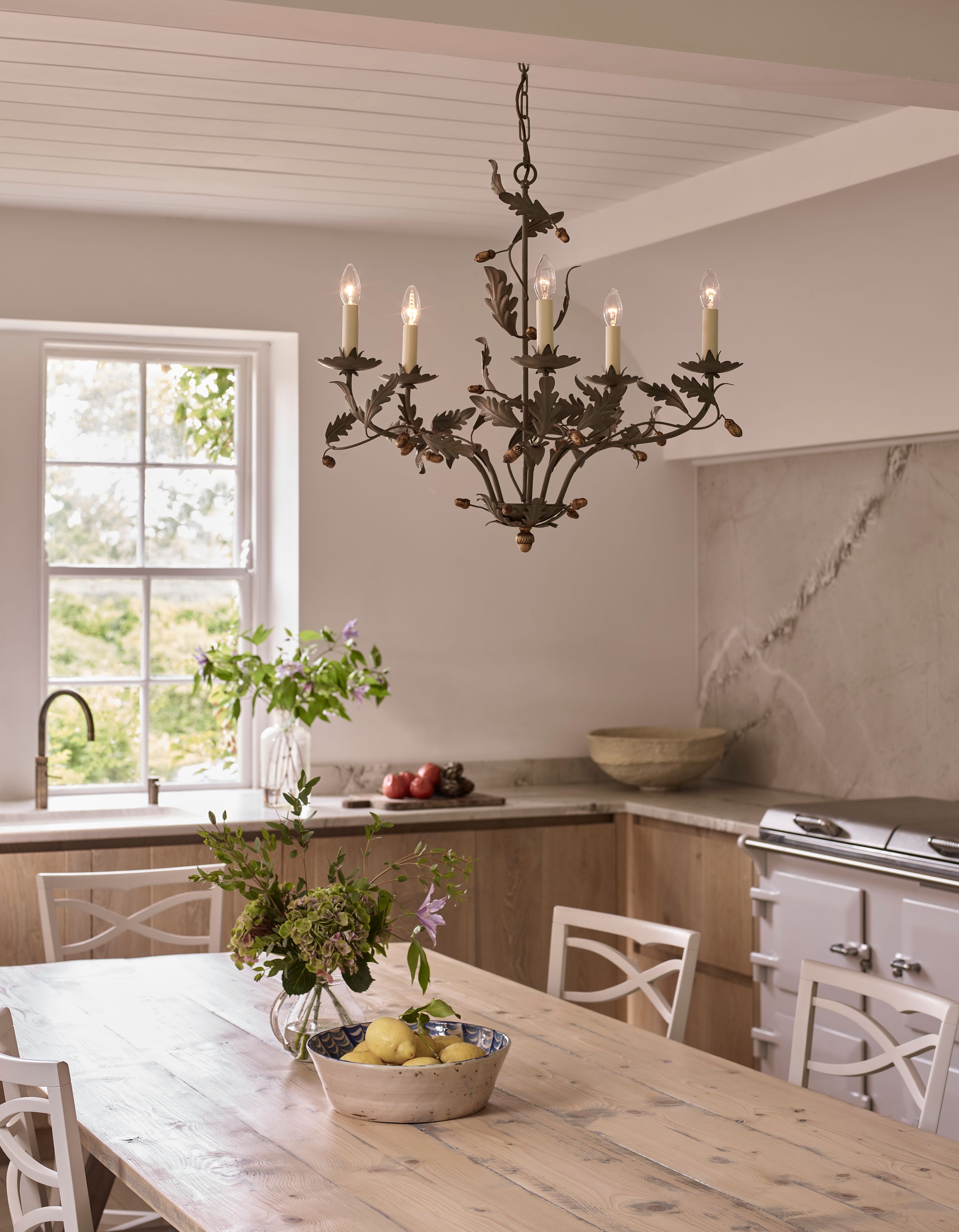 Image may contain: Architecture, Building, Dining Room, Dining Table, Furniture, Indoors, Room, Table, Chandelier, and Lamp