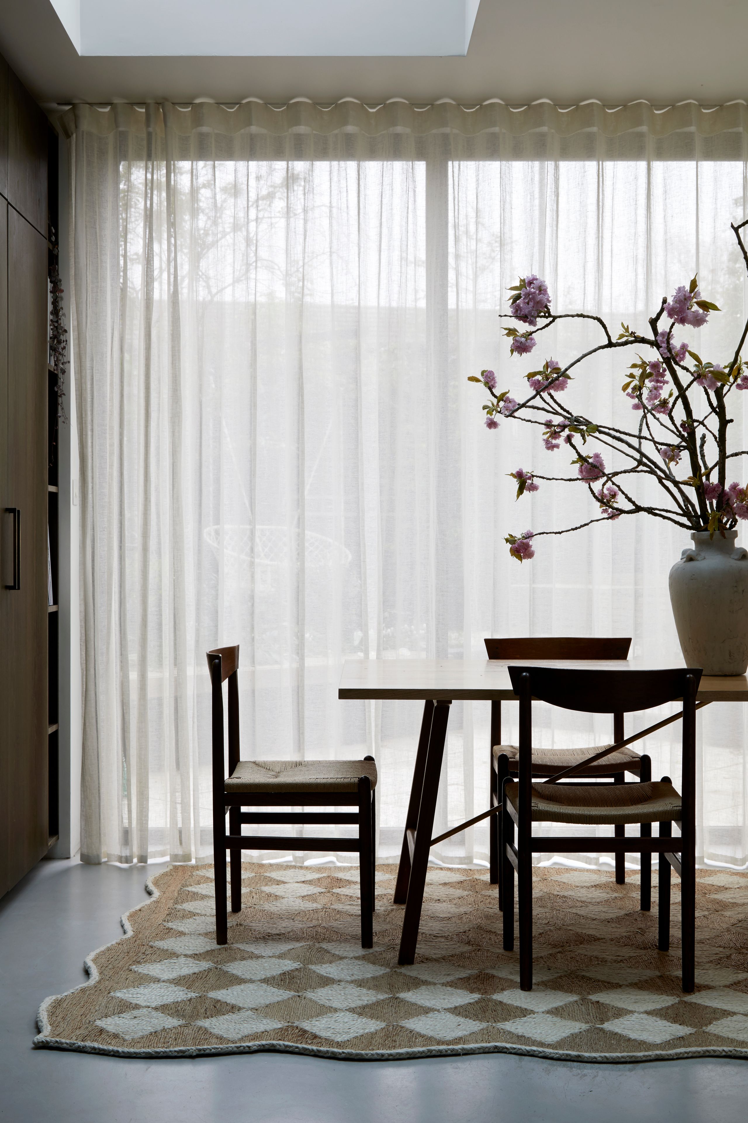 Image may contain: Home Decor, Chair, Furniture, Rug, Table, Dining Table, Architecture, Building, Dining Room, and Indoors