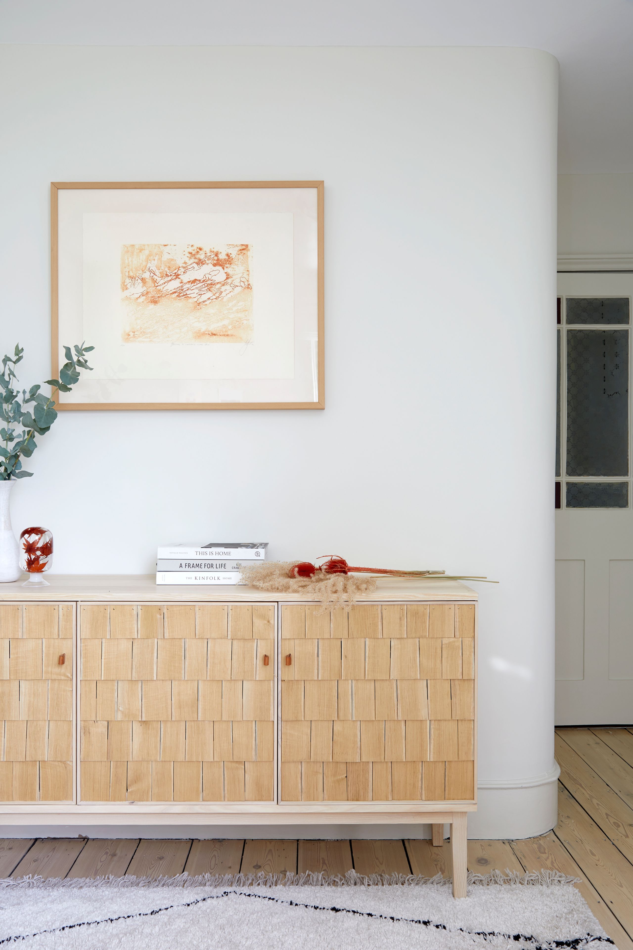 Image may contain: Furniture, Sideboard, Indoors, Interior Design, Plant, Art, Painting, Home Decor, Rug, and Cabinet