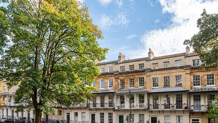 Image may contain: City, Urban, Plant, Car, Transportation, Vehicle, Architecture, Building, Housing, House, and High Rise