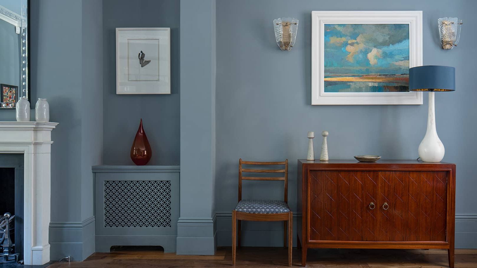 Image may contain: Indoors, Interior Design, Corner, Lamp, Chair, Furniture, Sideboard, Art, Painting, and Plate