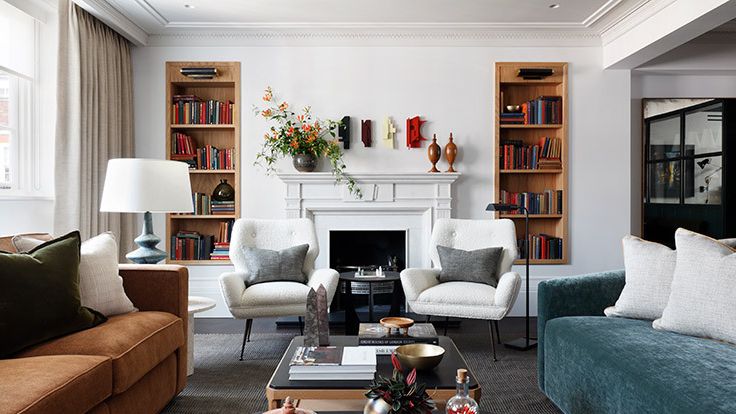 Image may contain: Home Decor, Architecture, Building, Furniture, Indoors, Living Room, Room, Table, Coffee Table, and Couch